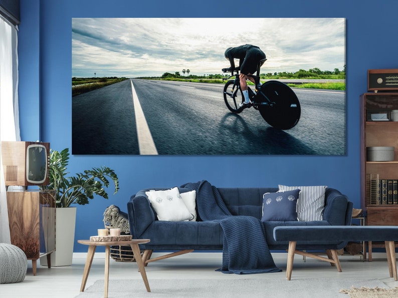 Cyclist riding a road racing bicycle with a forward-leaning posture on a straight road toward a bright horizon