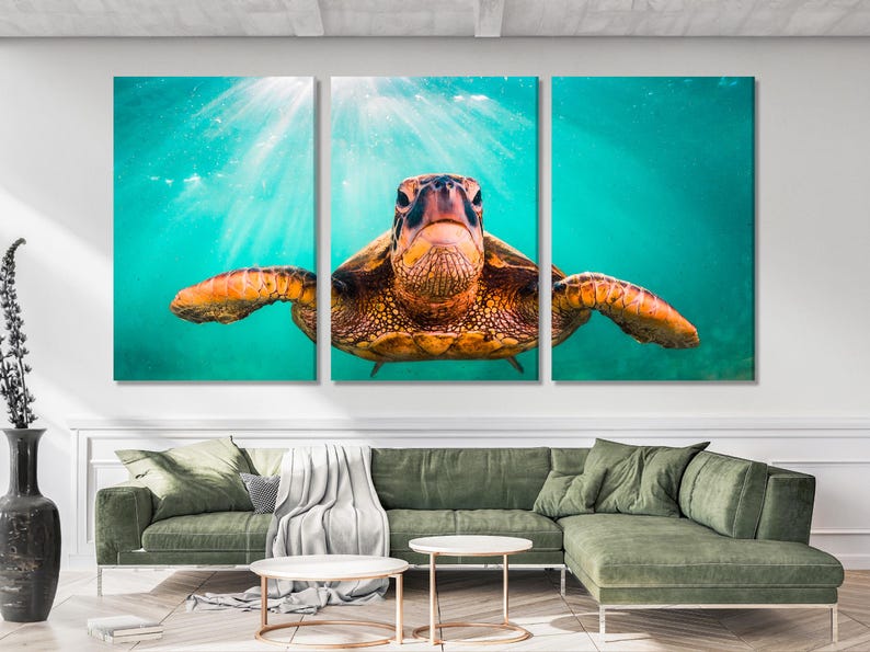 Underwater sea turtle swimming in turquoise water with diagonal sunrays