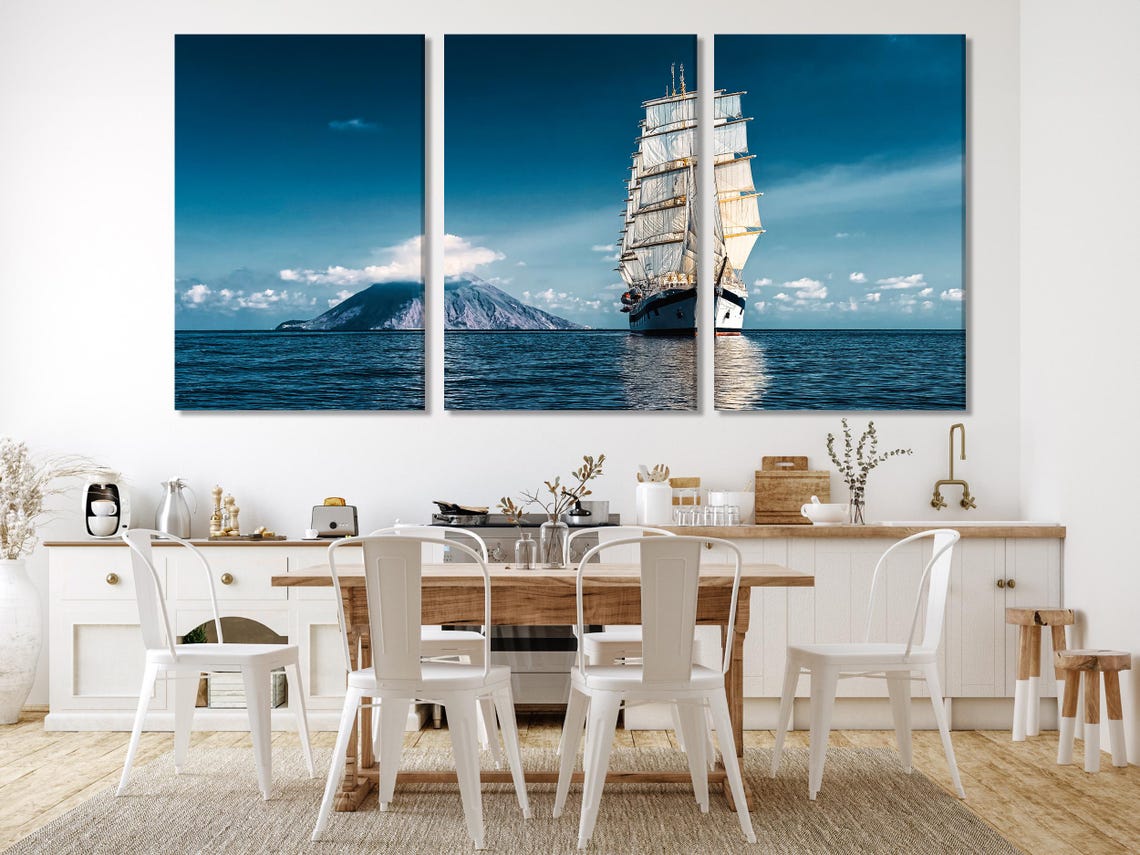 Sailing ship wall artwork displayed in a living room with wooden accents and lamps