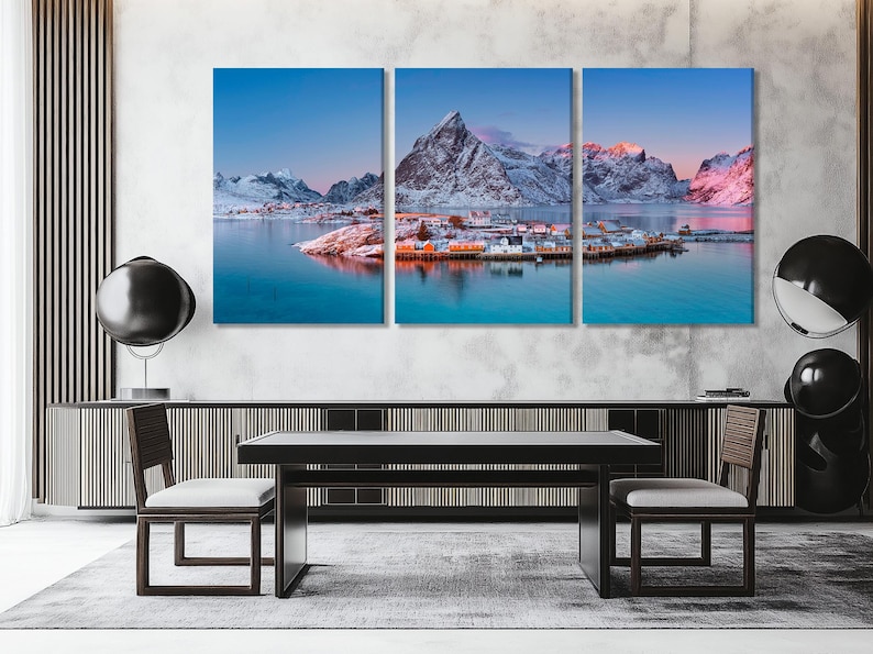Three-panel winter coastal landscape with snow mountains, calm water reflections and a harbour village at dusk