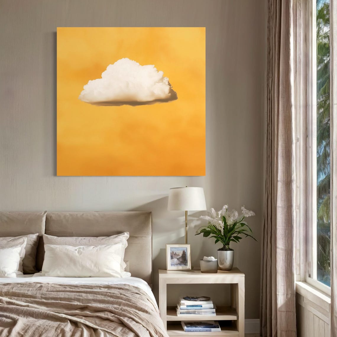 White cloud artwork hanging above a sofa with pillows in a bright room