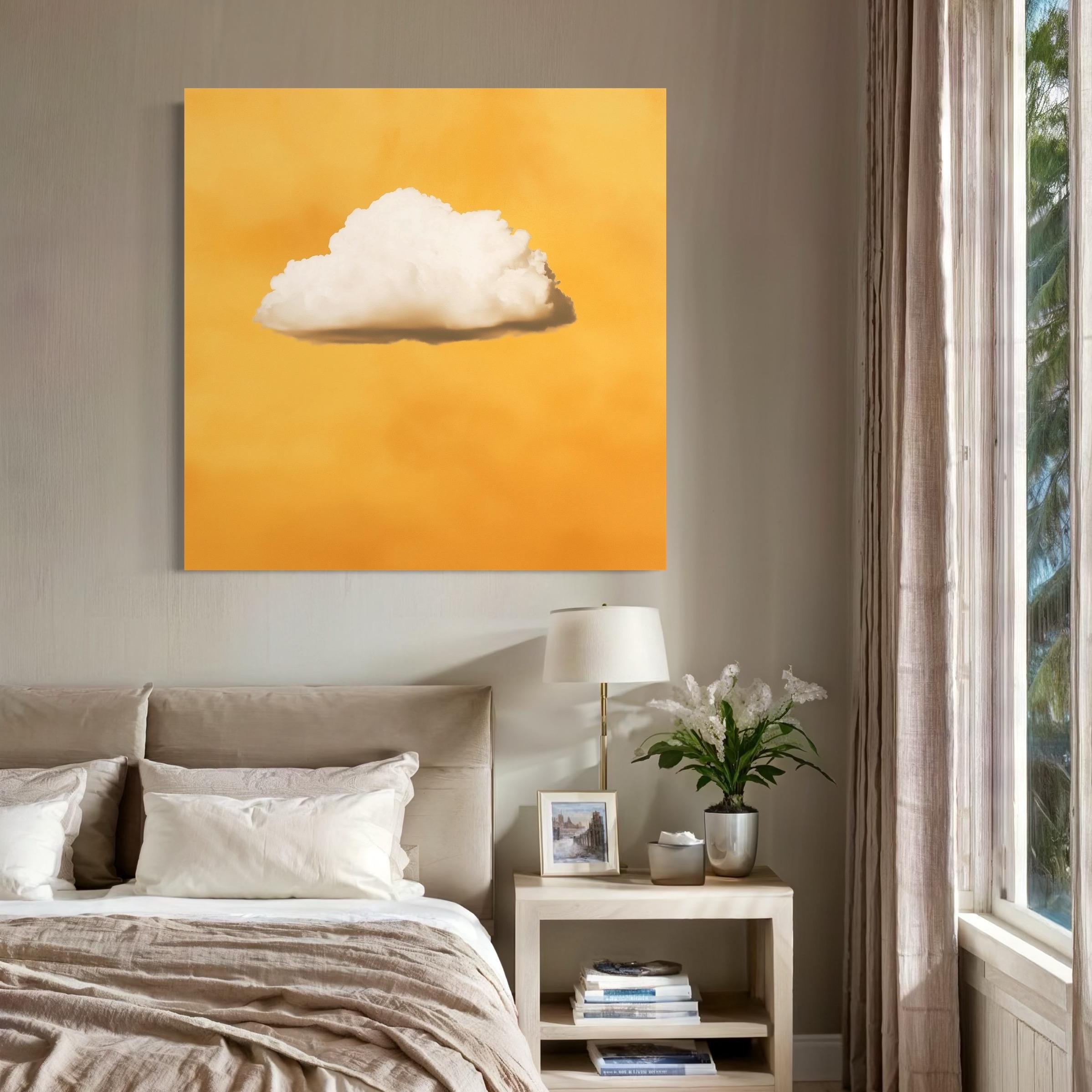 White cloud artwork hanging above a sofa with pillows in a bright room