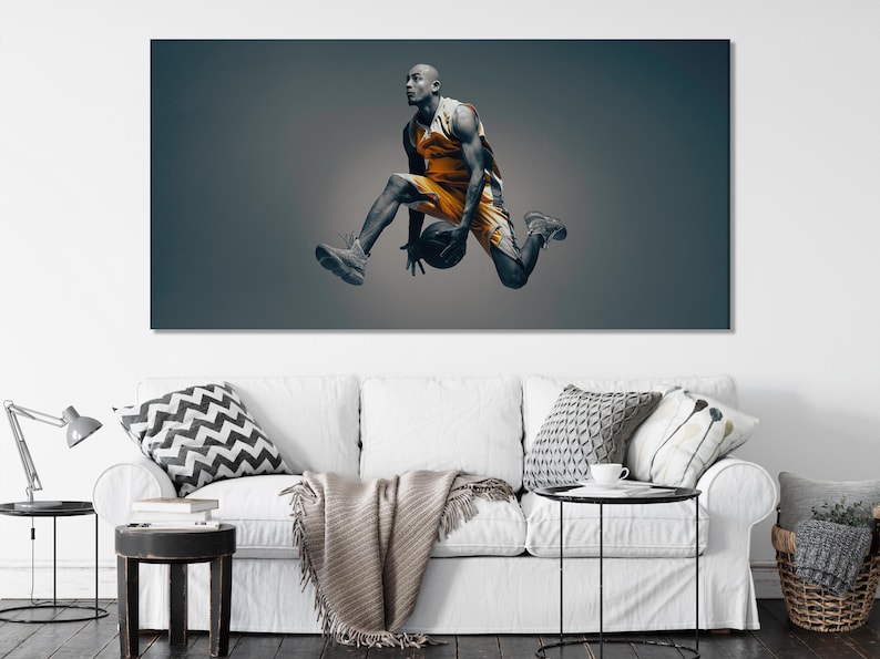 A black-and-silver basketball player is captured mid-air in a dynamic pose, framed by a muted teal-grey background with an orange jersey accent