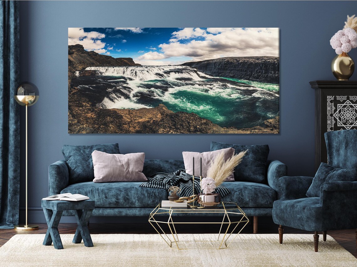 Room mockup with a row of five waterfall landscape artworks above a green sofa