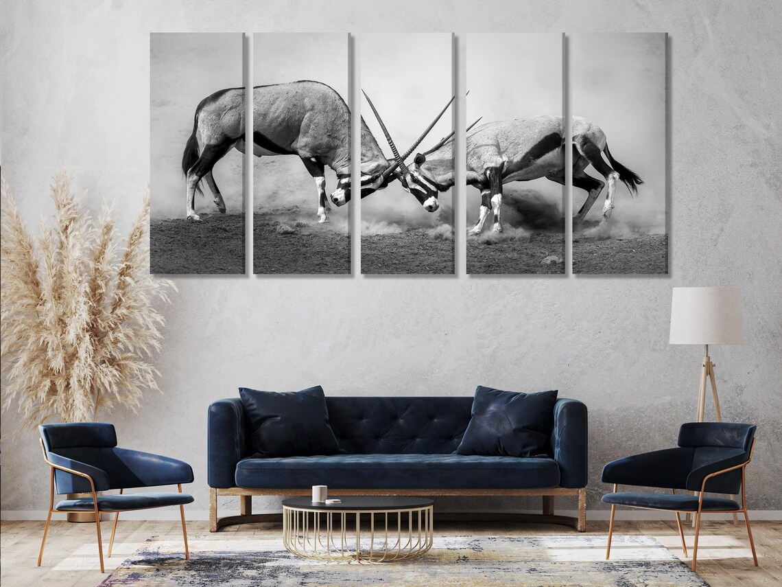 Triptych black-and-white wildlife artwork above a dining table in a bright room