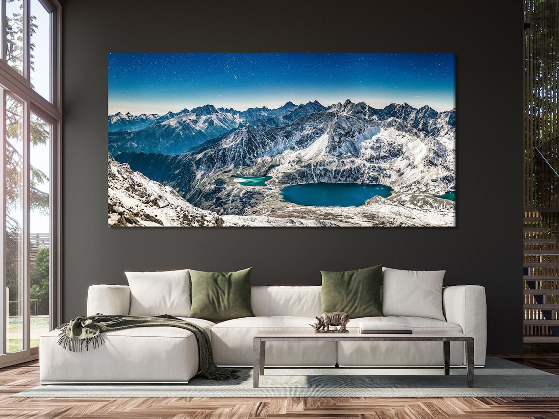 Room mockup showing vertical winter mountain artworks above a sofa