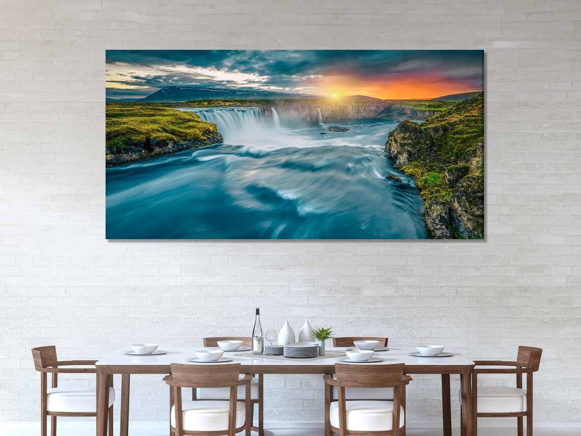 Three-panel waterfall landscape with rocky cliffs, green hills and sunset glow in cool teal and blue detail view