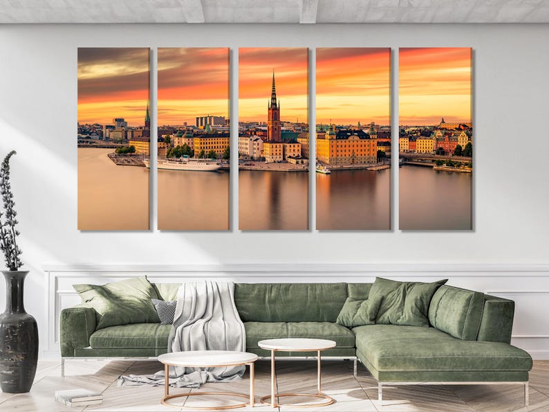 Warm sunset cityscape skyline with spired towers and reflections in calm water
