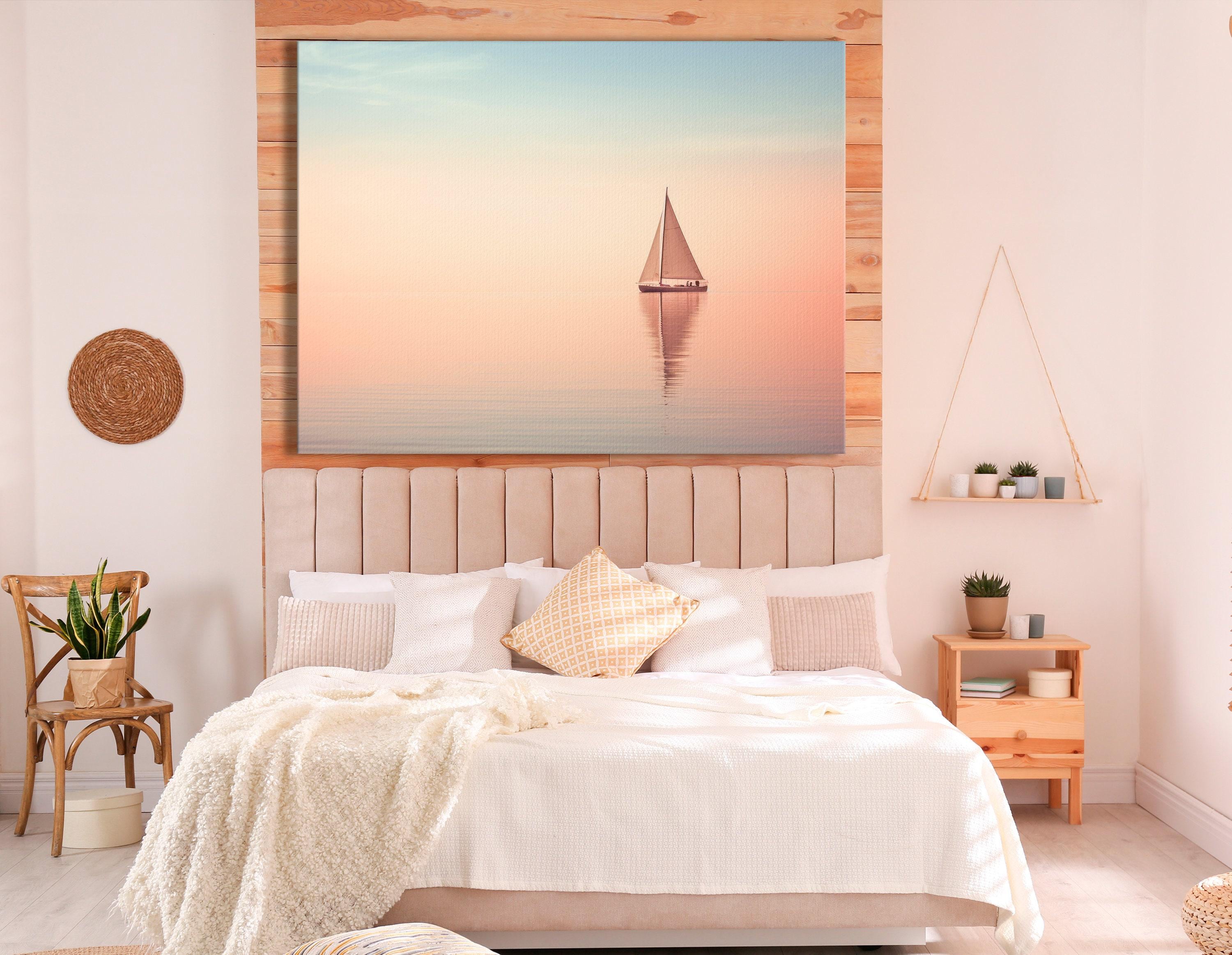Bedroom scene with a framed pastel sailboat seascape above a bed