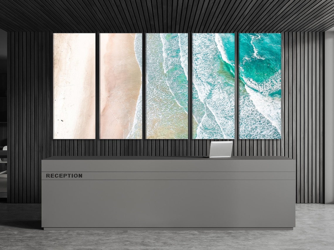 Bedroom scene with a large ocean shoreline artwork above the bed