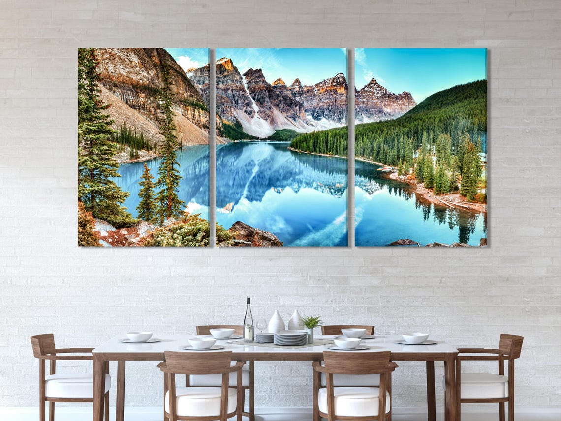 Room mockup showing multi-panel mountain lake landscape above a sofa