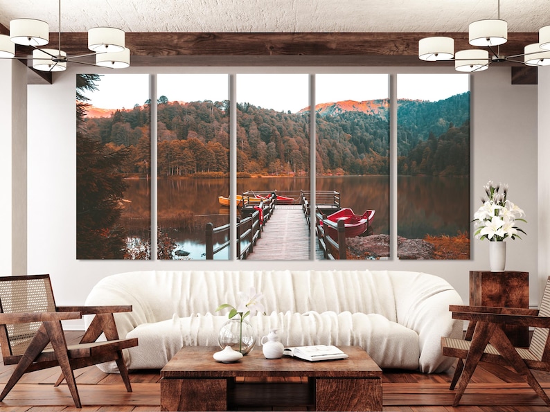 Autumn lake triptych showing a wooden dock, red boats, trees and distant mountains at dusk