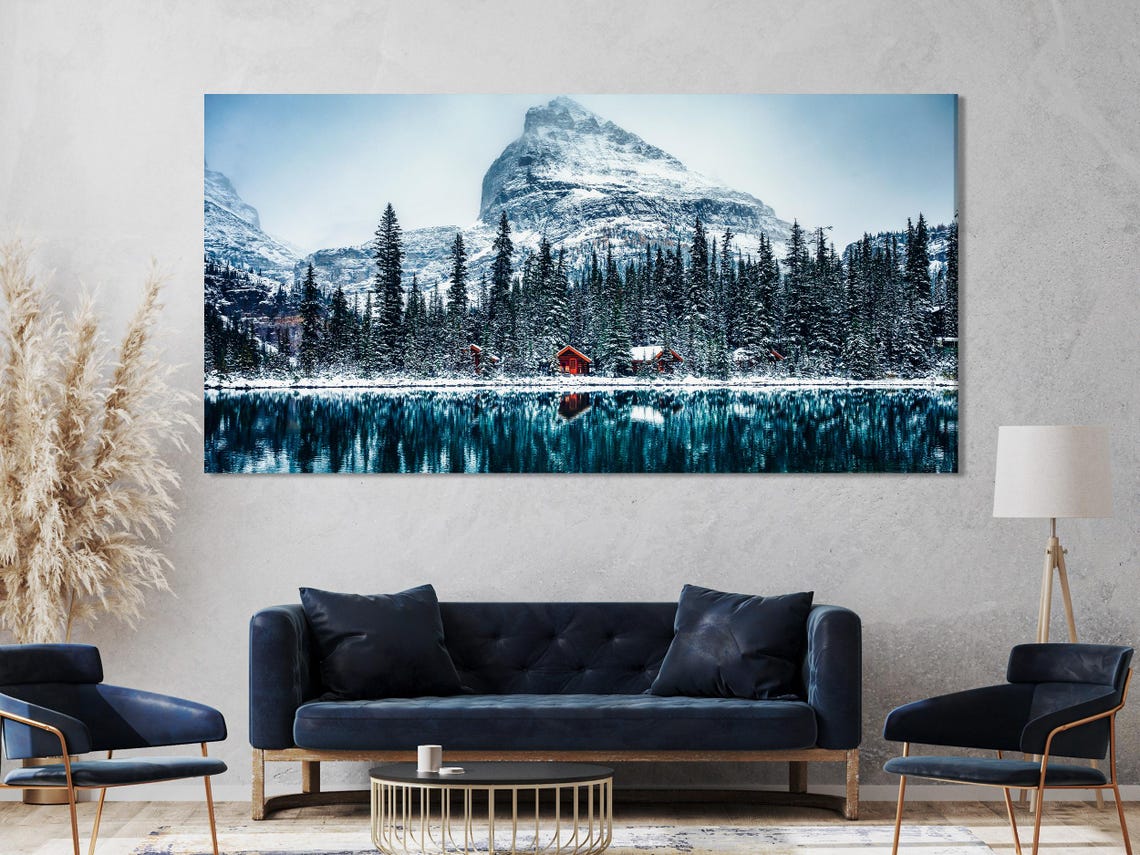 Room mockup showing snowy mountain panel artwork above a sofa