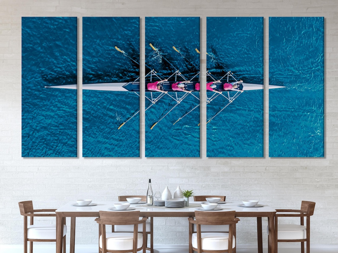 Mockup of a large blue rowing artwork above a sofa in a modern living room