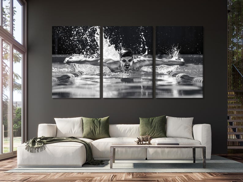 Black-and-white triptych of a swimmer in mid-butterfly stroke with water splashes and droplets