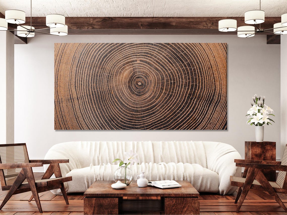 Room mockup showing a bed and a large framed wood-ring artwork above it