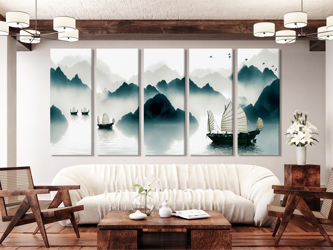 Misty mountain landscape in grey and teal tones with calm water reflections and small sailing boats detail view