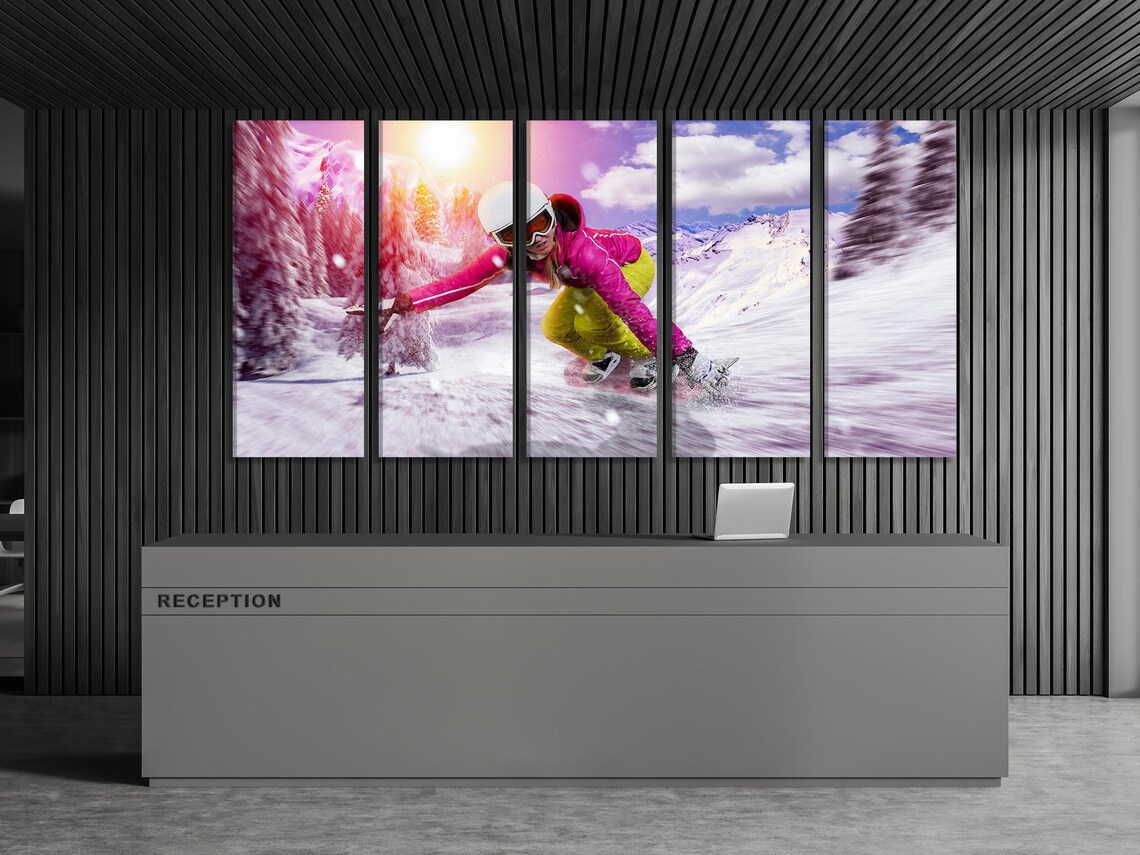 Living room mockup with three framed winter sports artworks showing a snowboarder on snowy mountains