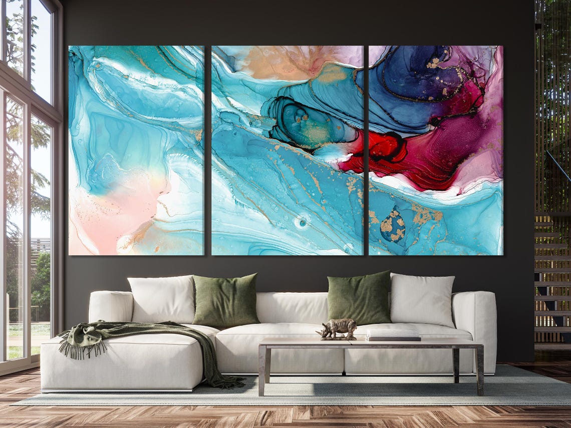 Fluid abstract five-panel artwork on a concrete wall above a sofa in a modern room
