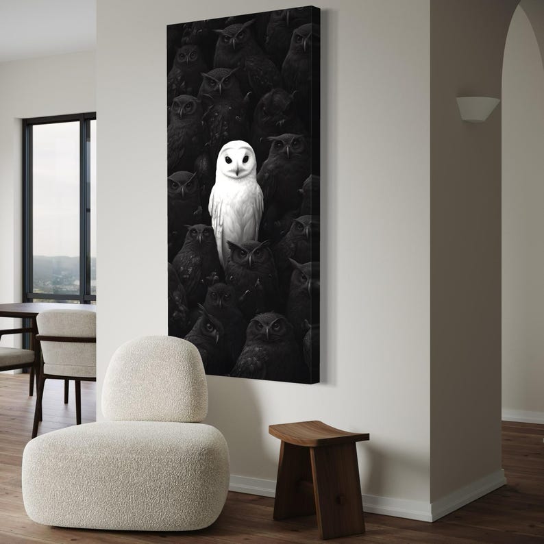 White owl in the centre surrounded by darker owls in a black and white composition