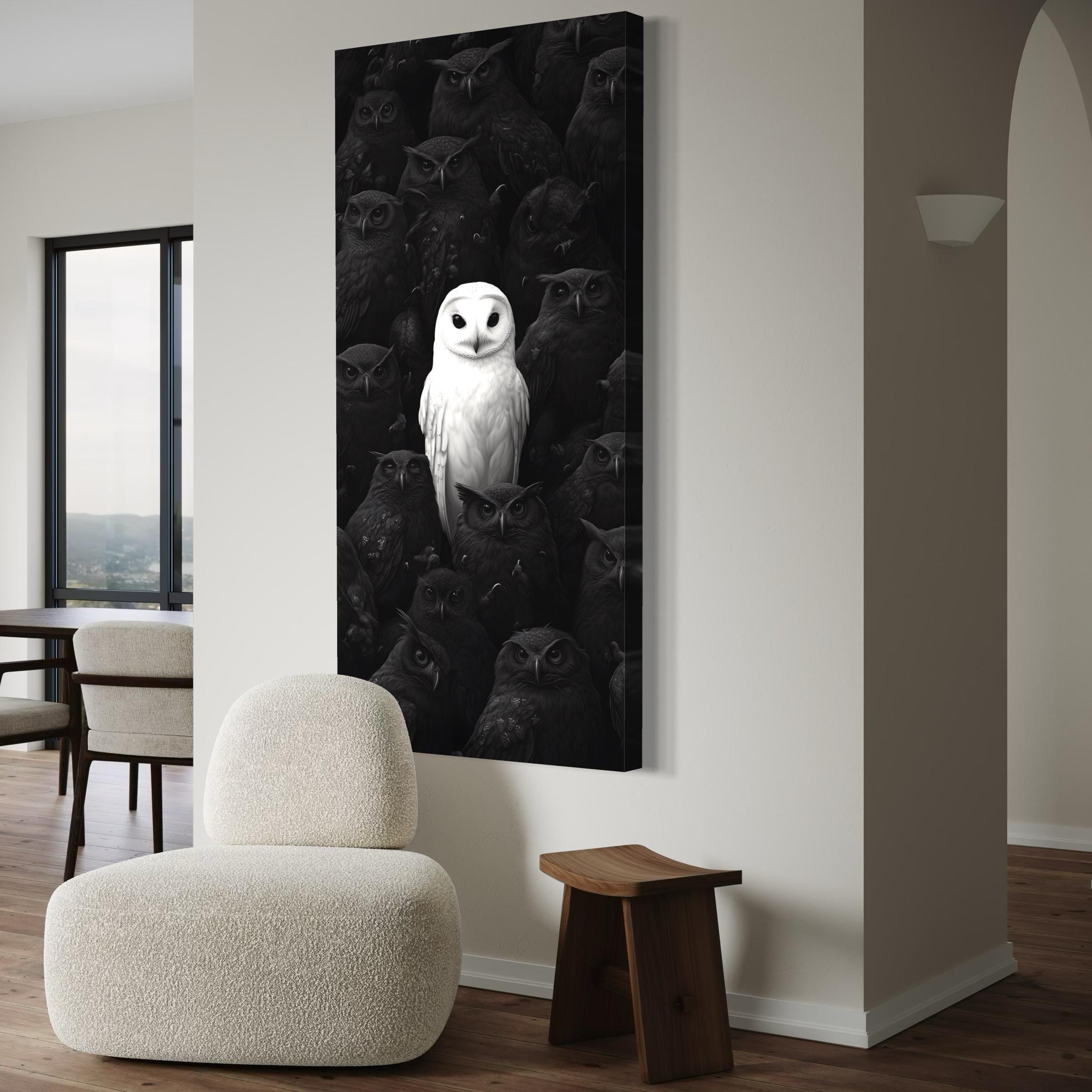 White owl in the centre surrounded by darker owls in a black and white composition