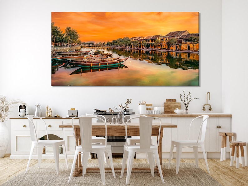 Warm sunset river with decorated boats, palm trees, and orange-gold reflections