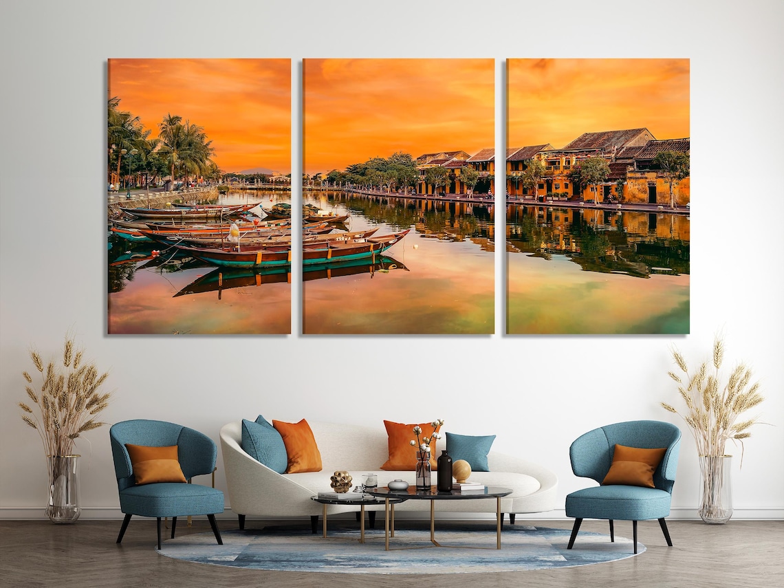 Dining room scene with a framed sunset river boats artwork on a wall