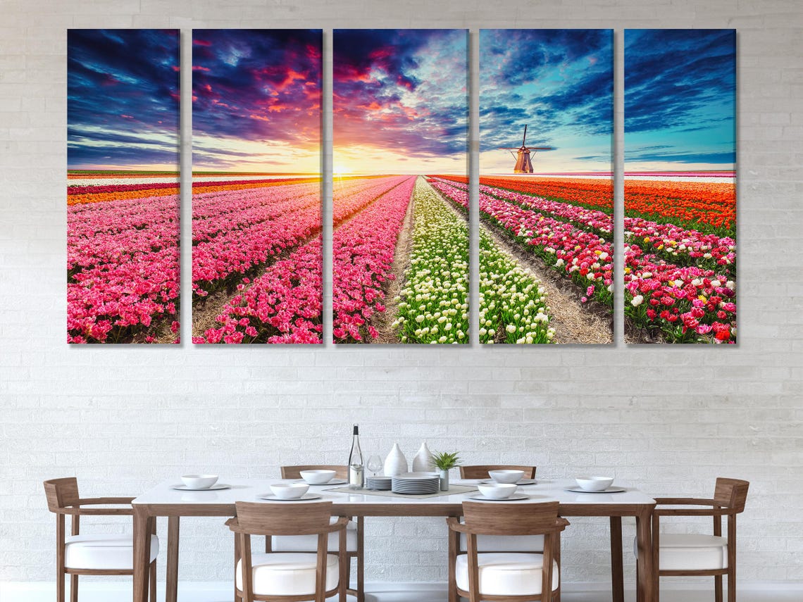 Room mockup with three panels of tulip field landscape wall art above a blue sofa