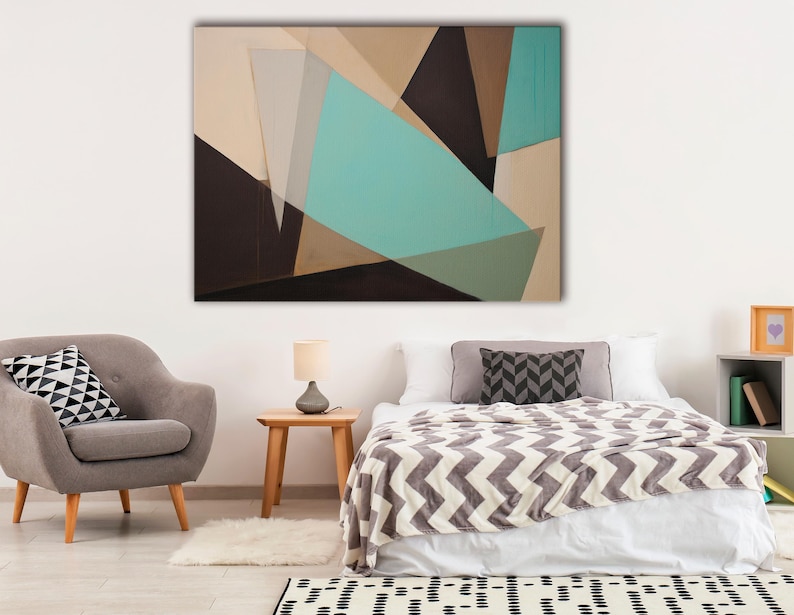 A geometric abstract composition of overlapping teal and beige shapes with dark charcoal accents forms an angular, layered look across a light