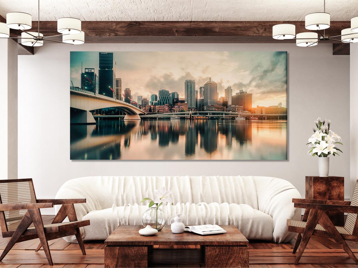 City skyline artwork above a green sofa in a bright living room