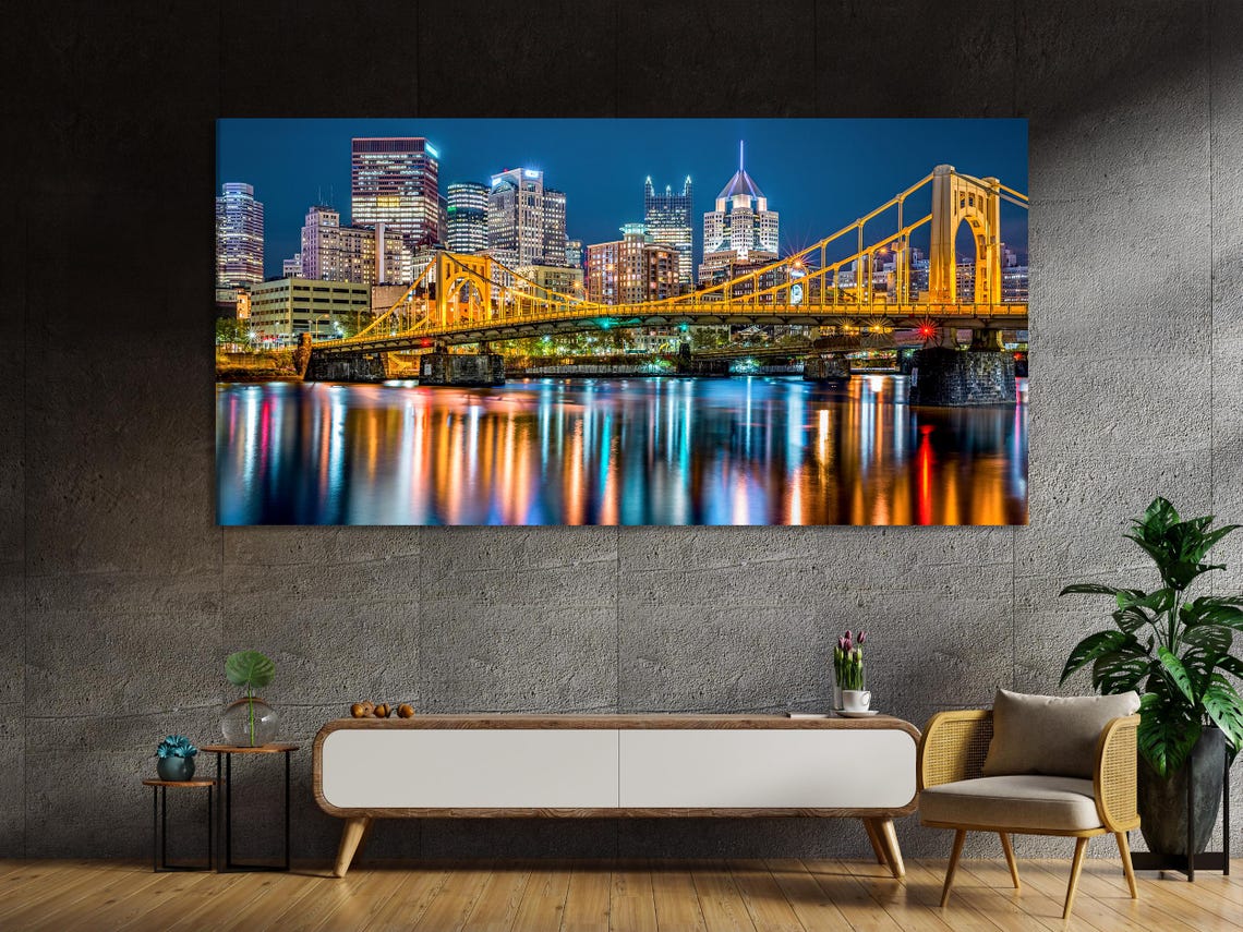 Five-panel night cityscape with a glowing gold bridge, skyscrapers and reflections in dark water detail view