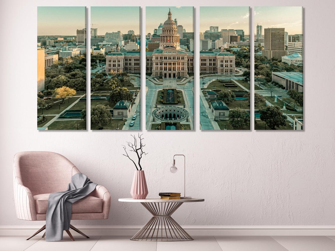 Room mockup with three multi-panel aerial city views above a sofa