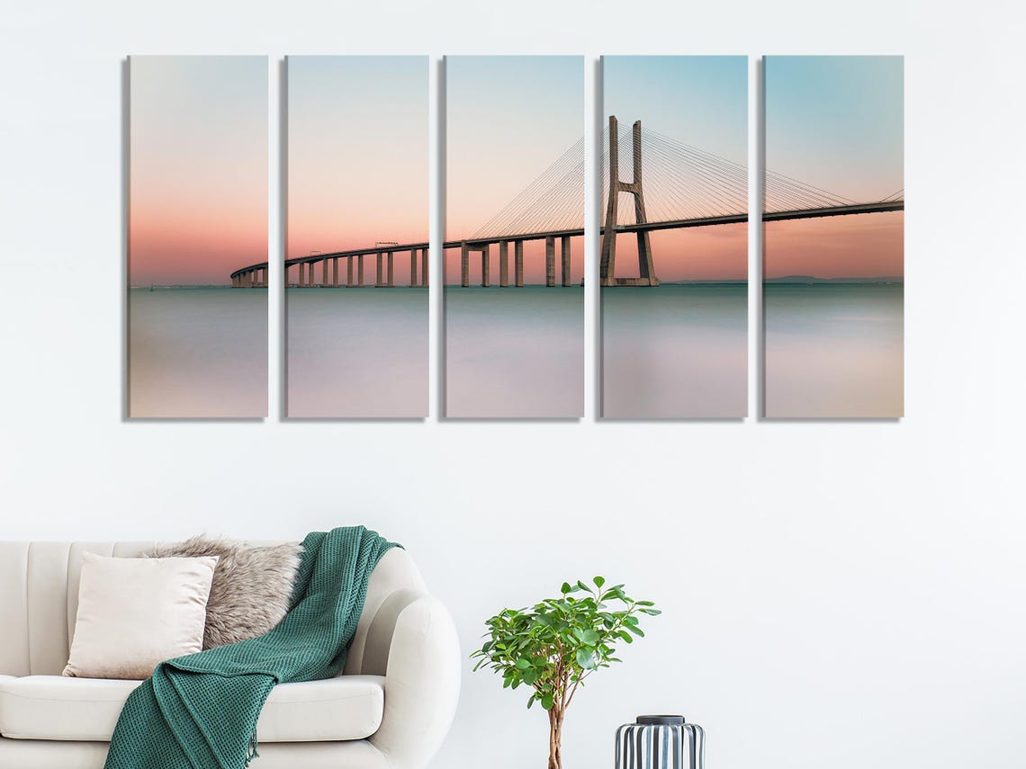Room mockup showing three panels of sunset bridge artwork above a console