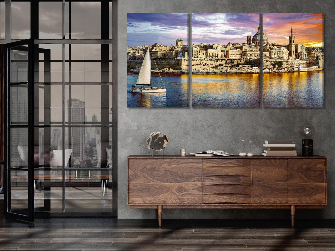 Living room mockup with a wall of five-panel sunset harbour cityscape artwork above a green sofa
