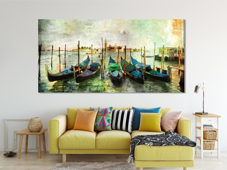 Colourful Venice gondolas moored at wooden posts with teal boat covers and rippled water reflections