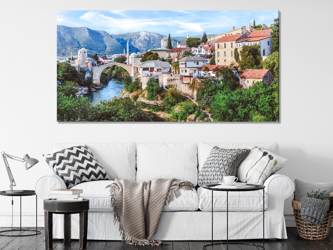 Room mockup with three-panel scenic bridge artwork above a sofa