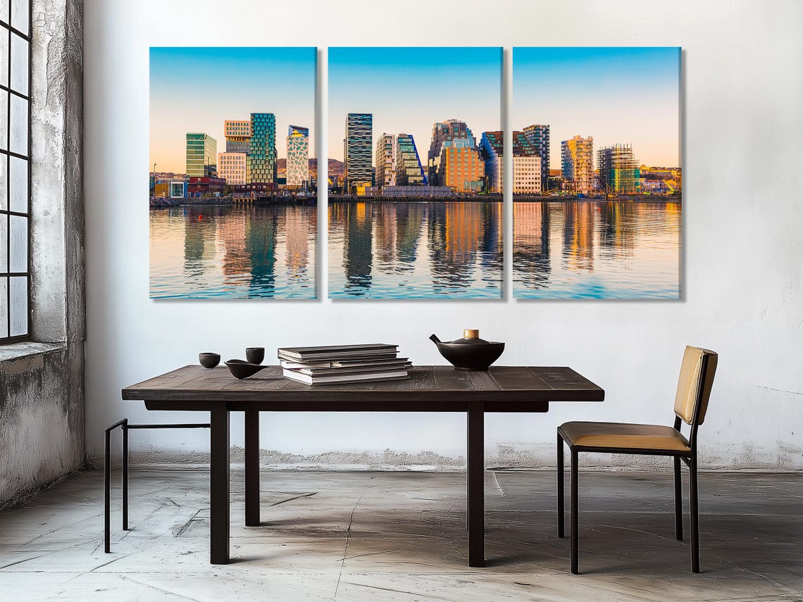 Room mockup showing a framed modern city skyline artwork above a desk and chairs