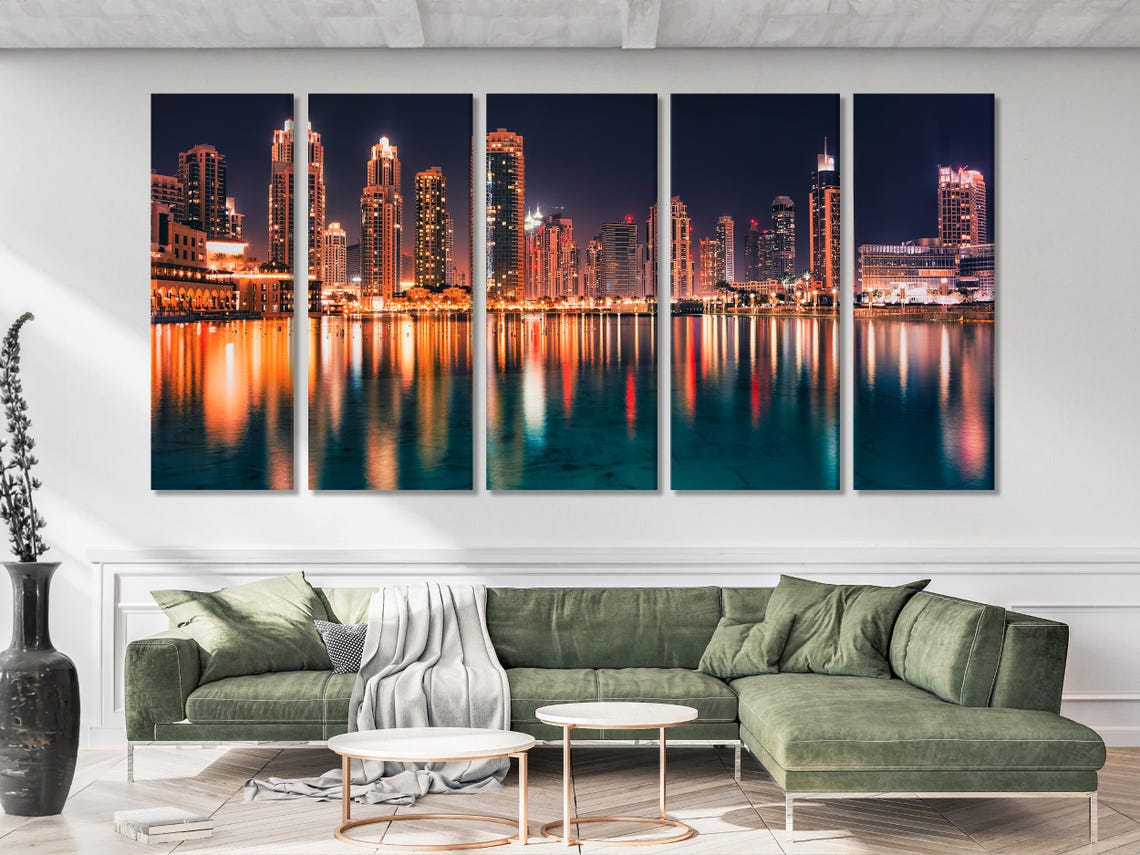 Night city skyline with illuminated skyscrapers and glowing reflections on water detail view