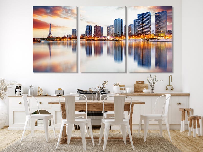 Triptych dusk city skyline with a tall tower, lit buildings and reflections on calm water