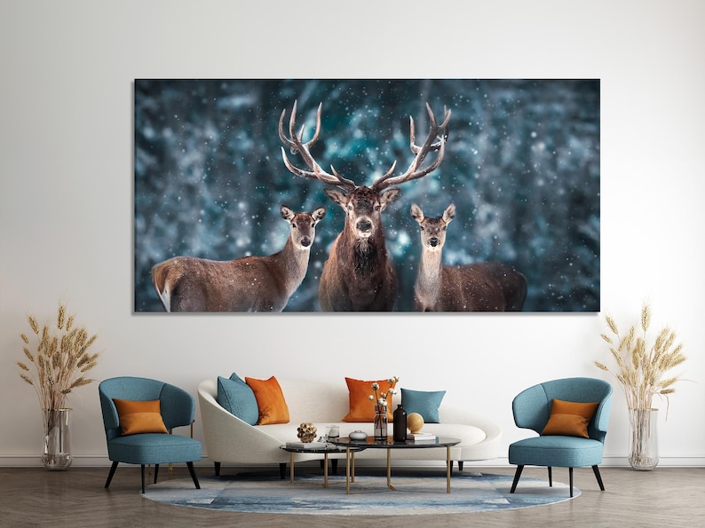 Three deer in a snowy blue forest, with a central stag showing branched antlers