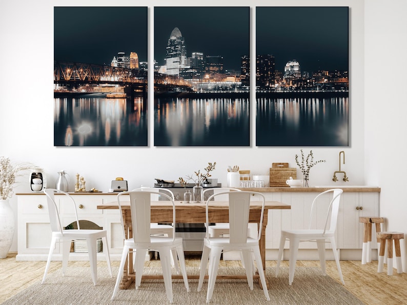 Three-panel night city skyline with a lit bridge and reflections on dark water