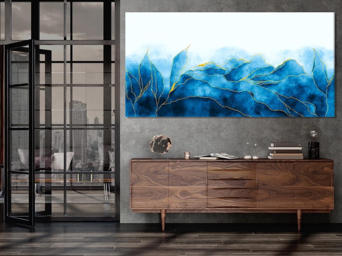 Room mockup with a sofa beneath five blue abstract wave panels with gold line accents