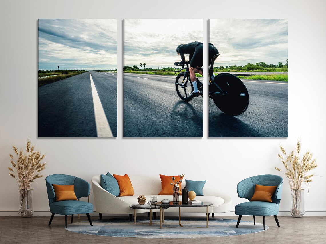 Cyclist riding a road racing bicycle with a forward-leaning posture on a straight road toward a bright horizon detail view