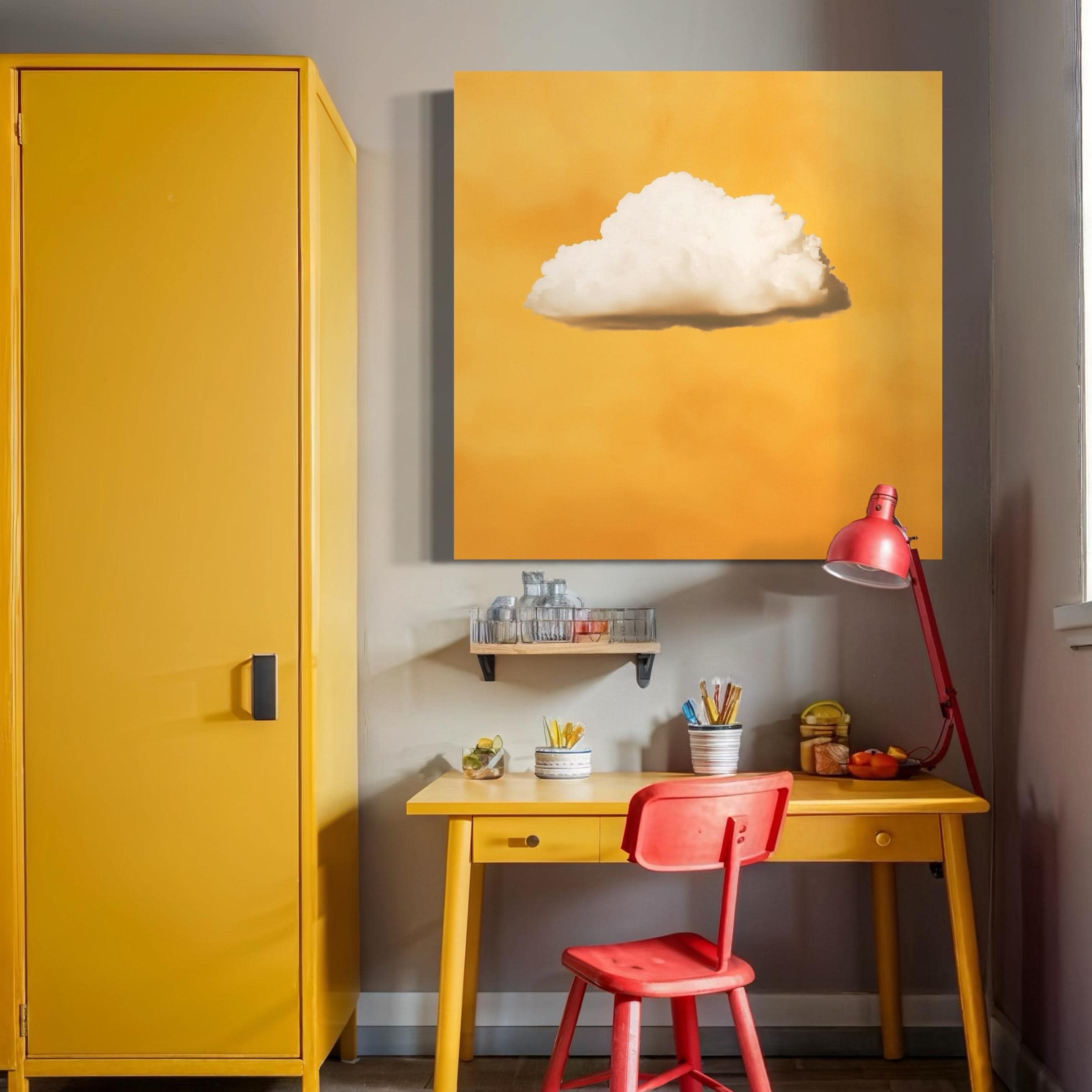 White cloud artwork hanging above a sofa with pillows in a bright room