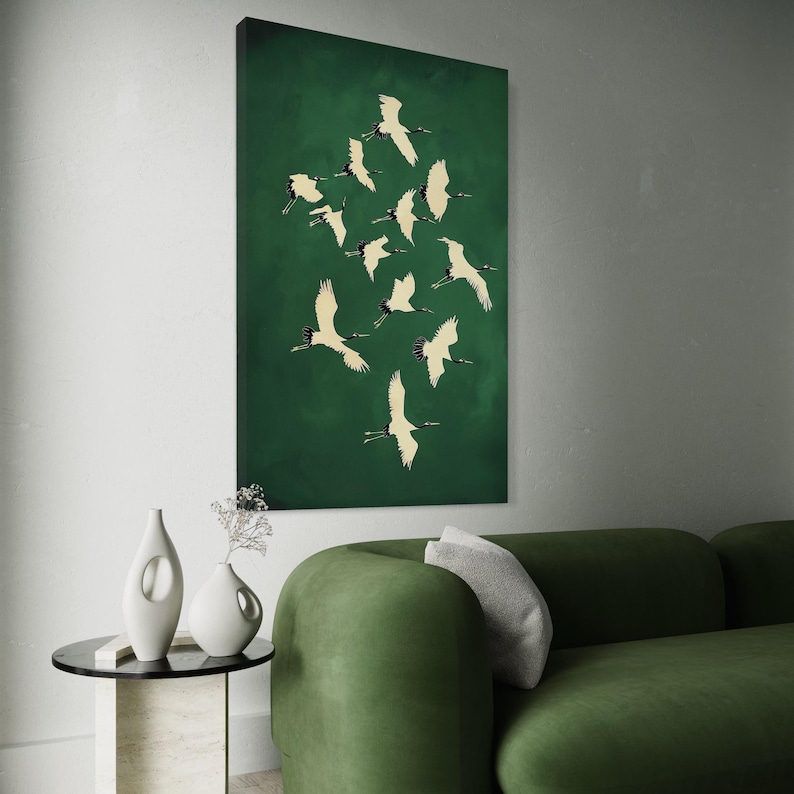 Emerald green wall art showing multiple cranes in flight with cream and black silhouettes