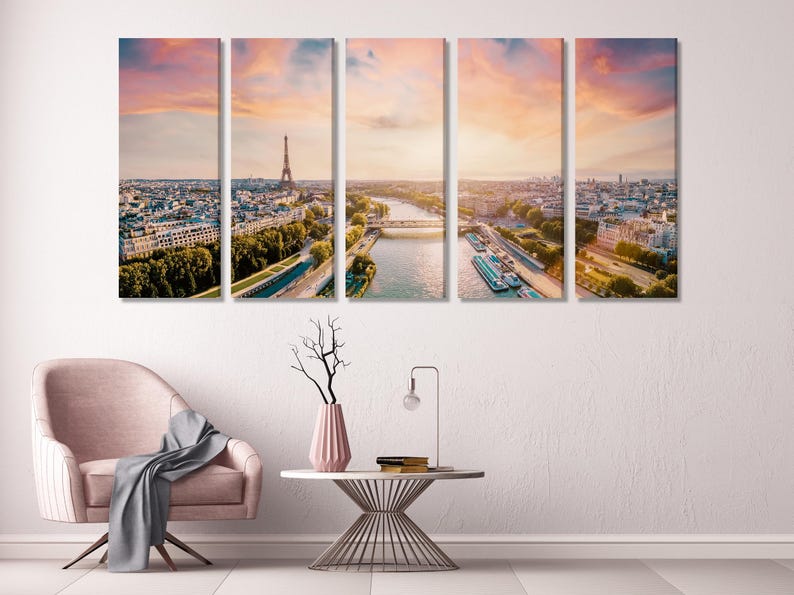 A warm-toned aerial city view of Paris across multiple panels, with a tall metal tower and a river curving through parks and buildings under a pastel