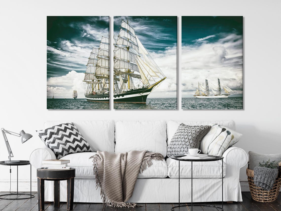 Sailing ship artwork on a wall above a dining table