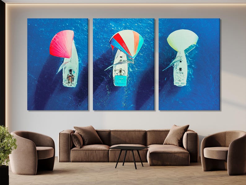 Aerial triptych of sailboats on deep blue ocean with bright red and pale green spinnaker sails