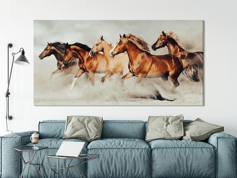 Four galloping horses in warm brown and cream tones with dust haze on a pale background