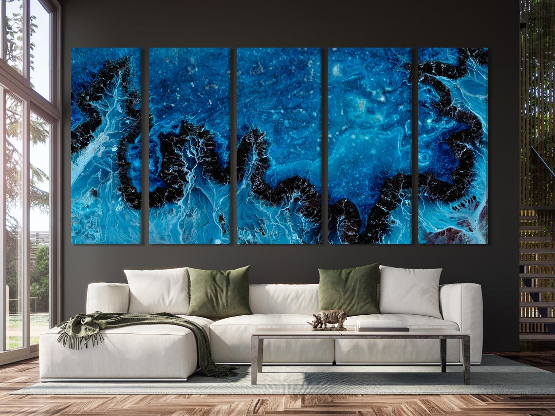 Room mockup showing a deep blue abstract artwork above a sofa